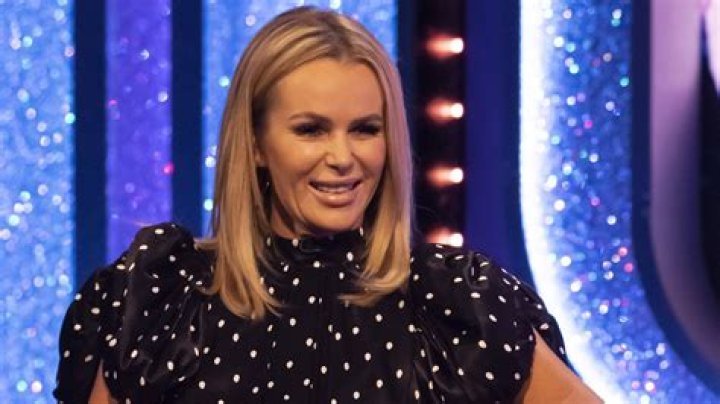 Amanda Holden slips into mini dress and stockings for Halloween fun