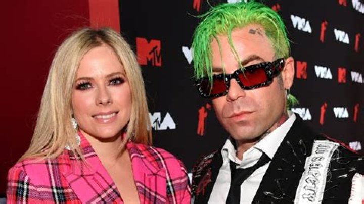 Avril Lavigne flashes midriff in cropped sweater and eye-catching pants as she talks major commitment to boyfriend Mod Sun