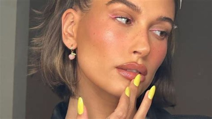 Hailey Bieber ignores Selena Gomez drama to start new yellow gel nail trend: lemon meringue manicure