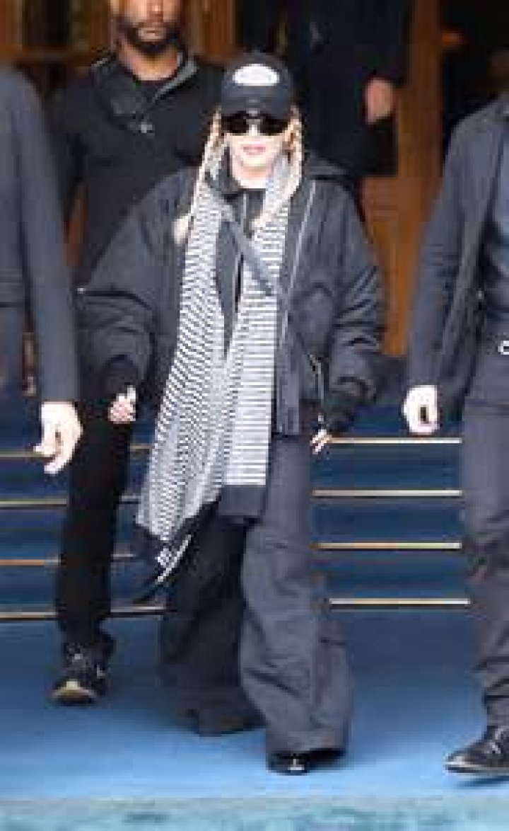 Madonna, 65, has son David Banda, 18, close at hand as she steps out in Paris after near brush with death