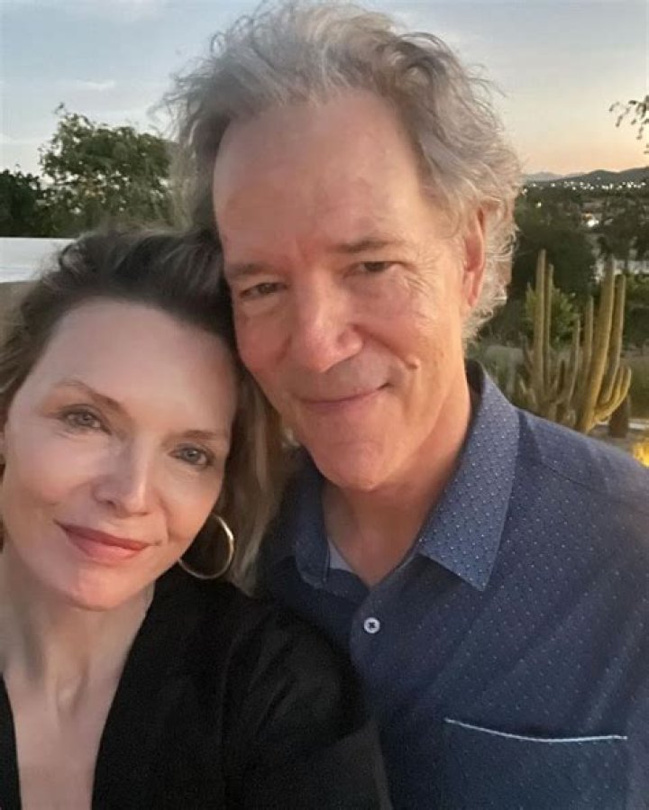 Michelle Pfeiffer looks radiant as she cozies up to husband David E. Kelley in romantic new photo