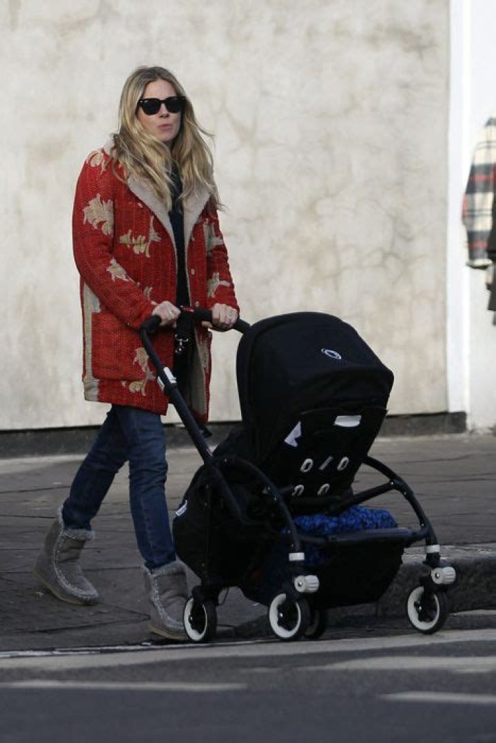 Sienna Miller shows off her daughter Marlowe during a stroll through London